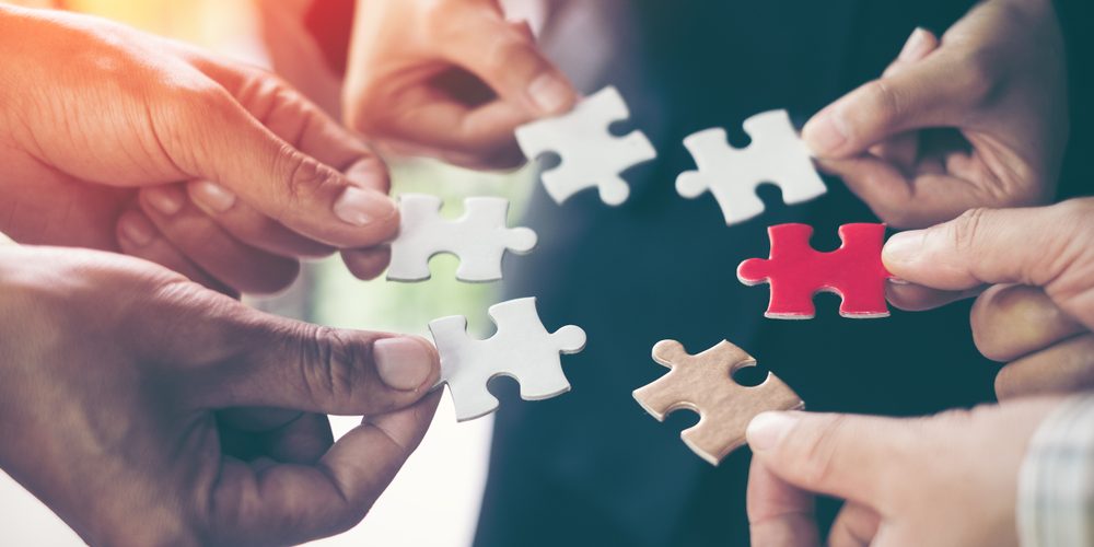 Hands,Holding,Piece,Of,Blank,Jigsaw,Puzzle,For,Teamwork,Workplace client engagement concept